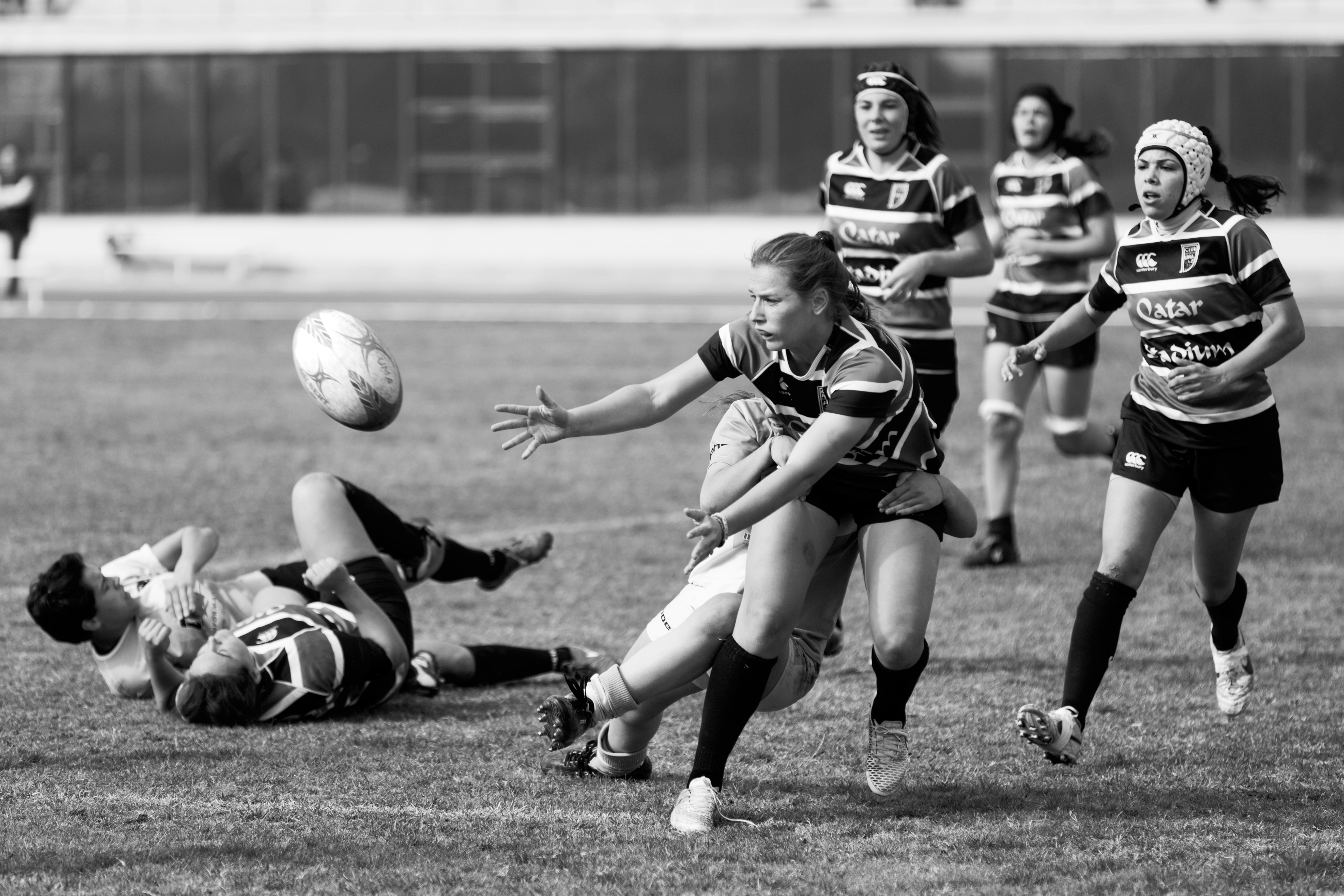 grayscale photo of a woman playing soccer